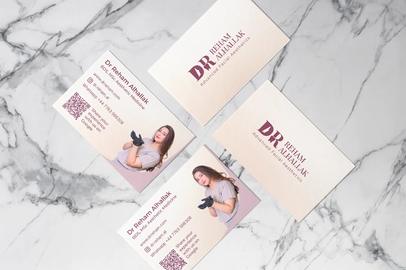 Metal business card holder with gold cards featuring subtle pattern and contact info on marble surface.