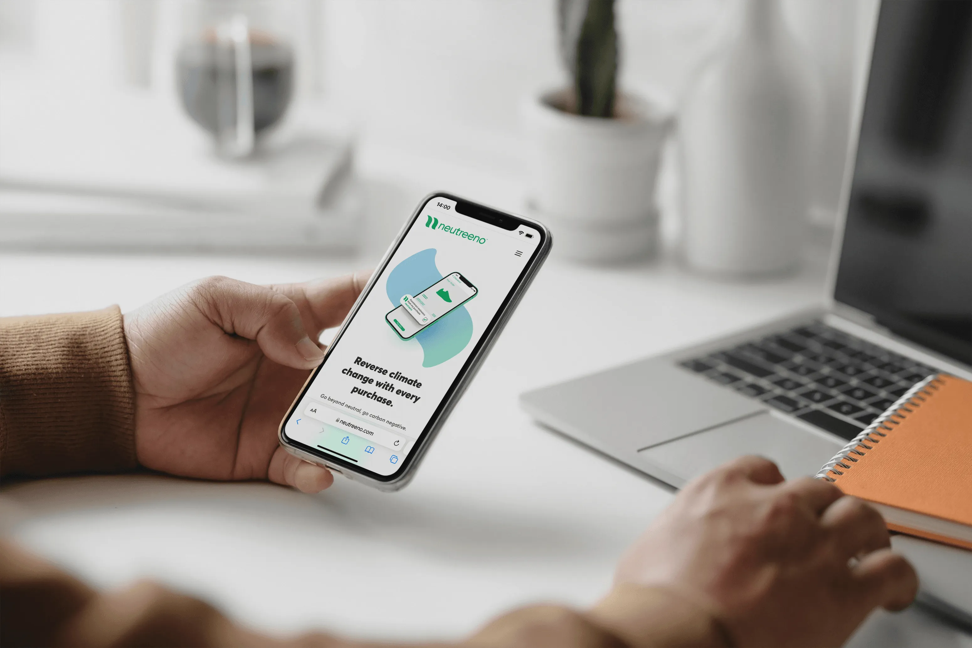 Person holding smartphone displaying Neutreeno app about reversing climate change with purchases.